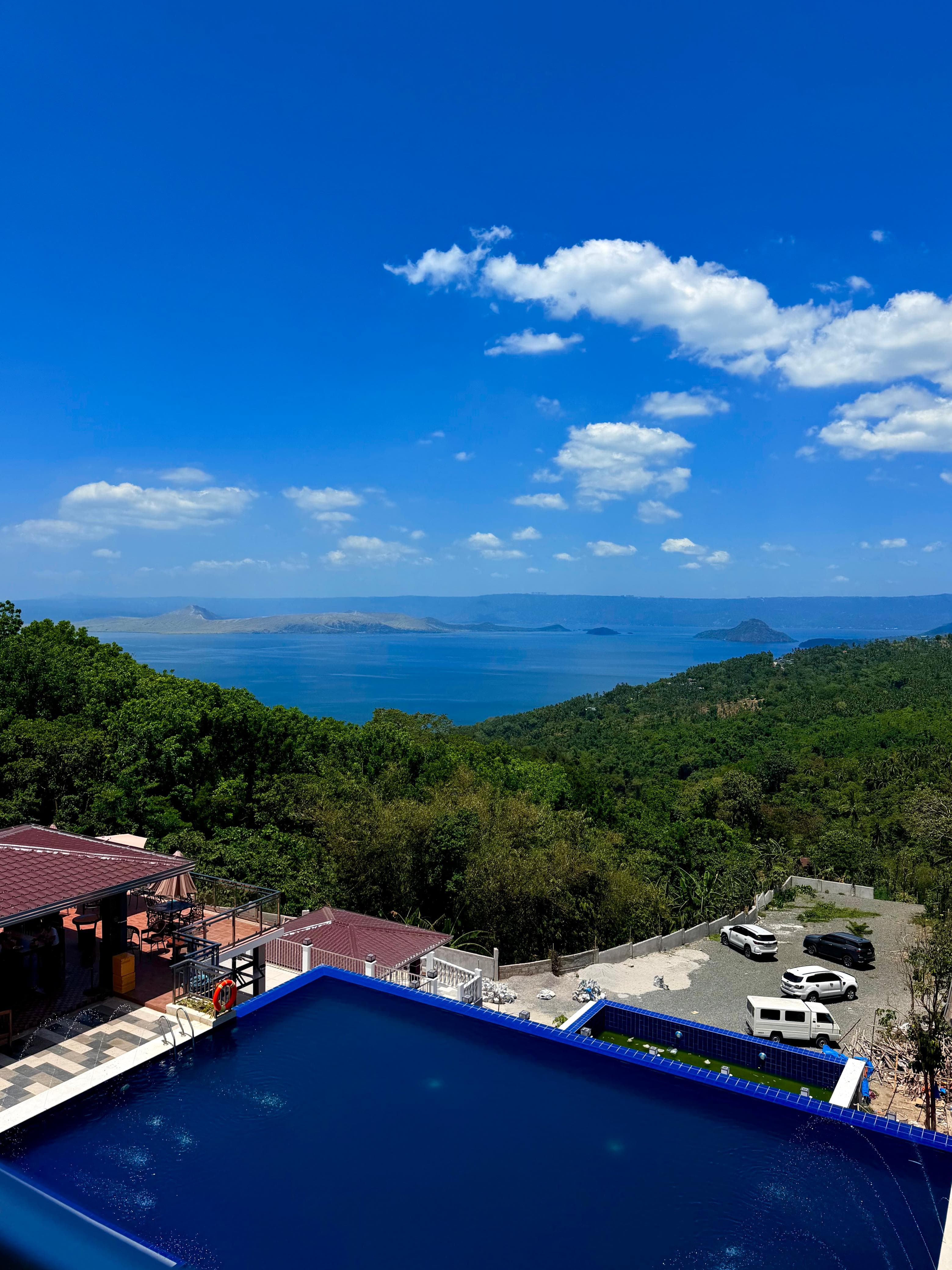 Infinity pool with Taal Lake on a sunny day